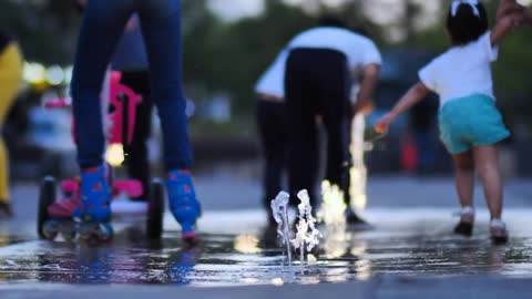 Children playing with a dancing fountain