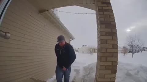 Guy Slips While Holding A Cooler And Going Down Snowy Stairs