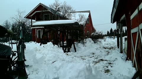 Towable miniexcavator remowing heavy snow