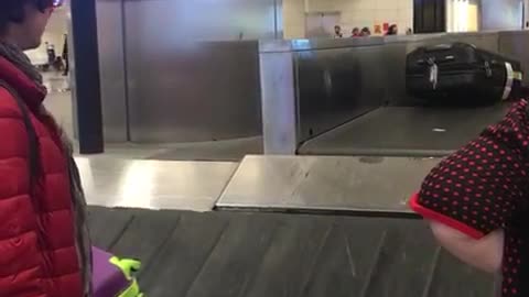 Man Appears to Direct Luggage at Barcelona Airport Baggage Claim