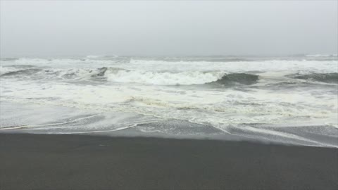 Waves Crashing onto a Black Sand Beach