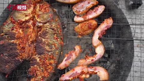 Grilled salted fish is a delicacy in southeastern Guizhou, China