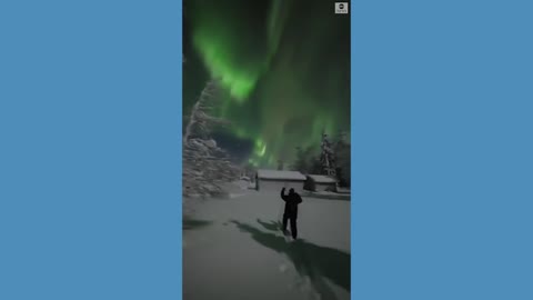 Skiers enjoy aurora borealis in Finland.