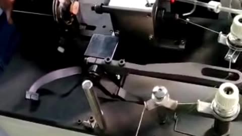 Coat button attaching machine