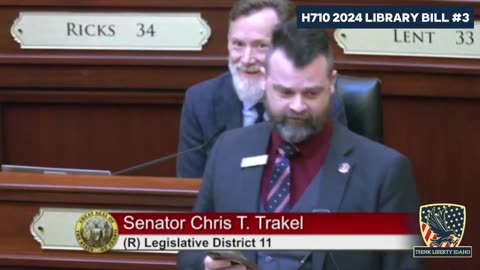 Idaho State Senator Chris Trakel reads from "Lets' Talk About it" during debate on H 710