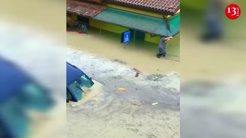 Water flows down the street, as floods hit Italy's northern Emilia-Romagna region