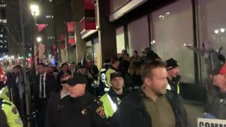 Castrudeau is swarmed by angry protestors as he is shielded by dozens of police...