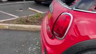 Aftermath of Storm Causing Roof to Land on Cars in Parking Lot
