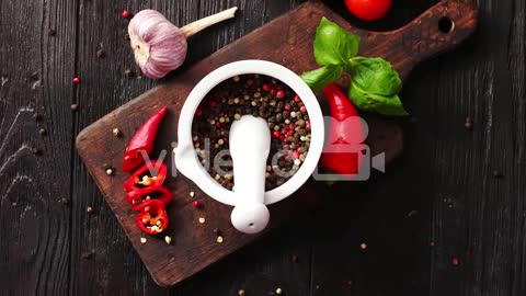 Bowl with spices on chopping board