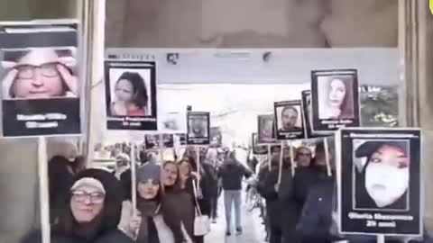 Family members holding up photos of vaccination deaths - Italy