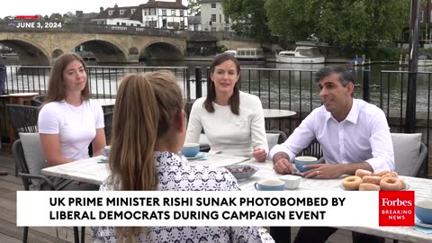 WATCH- UK Prime Minister Rishi Sunak Photobombed By Liberal Democrats During Campaign Event