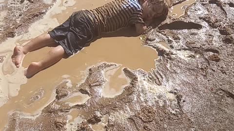 Child Falls Asleep in Mud Puddle