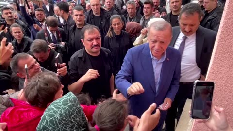 Erdogan hands cash to supporters at polling station