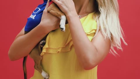 A Dog Owner Cuddle with a Cute Puppy