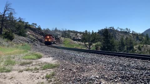 Solid EMD SD70ACe lineup up Mullan Pass. 3 BNSF, 4 MRL, then 1 BNSF on the rear.