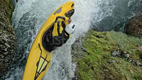 SLO MO Whitewater kayaker in a yellow kayak dropping a waterfall