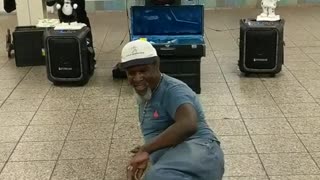 Man in blue shirt jeans dancing subway station