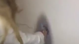 Girl punches hole through bathroom wall