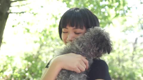 Asian Woman Black Dog Embrace With Light