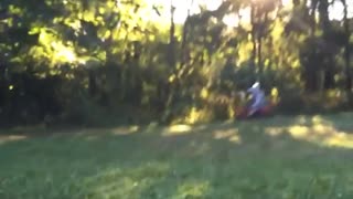 Person falls off of red motorcycle dirt bike grass