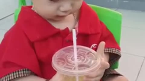 The baby drinks sugarcane juice