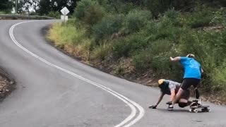 Downhill Skateboarder Takes Out Cameraman