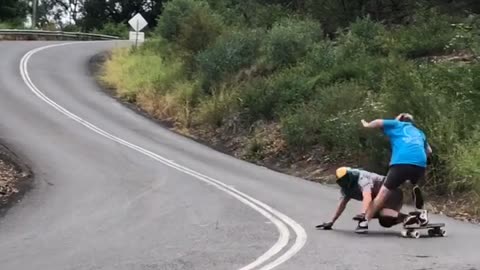 Downhill Skateboarder Takes Out Cameraman