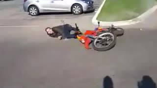 Man falls off a red dirt motorcycle