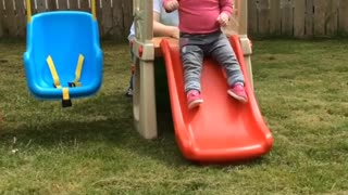 Baby faceplants off slide