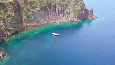 aerial view of a yachts in the blue sea of the capraia island in the mediterranean sea