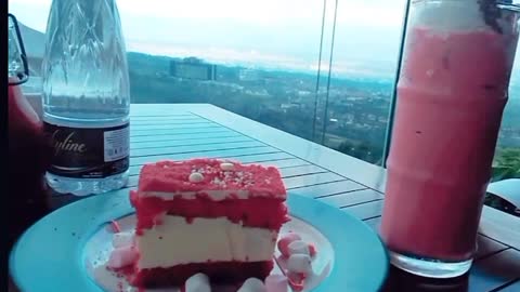 Enjoy the beautiful view at the cafe with red velvet cake and strawberry milkshake