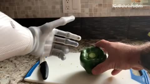 Guy cuts green bell pepper with bionic arm and smashes it