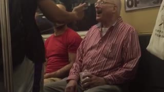 A man in red sings on train woman gets up