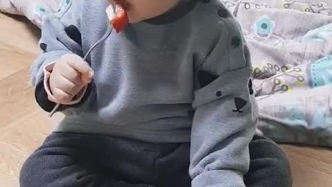 baby eating strawberries