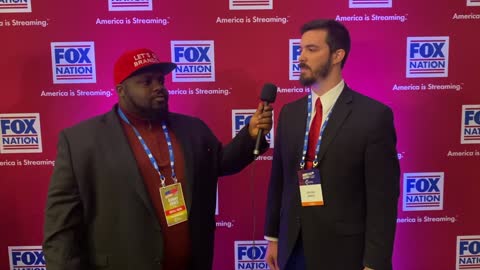 Ron J Spike speaking with Official Peer Politics, at AmericaFest 2021