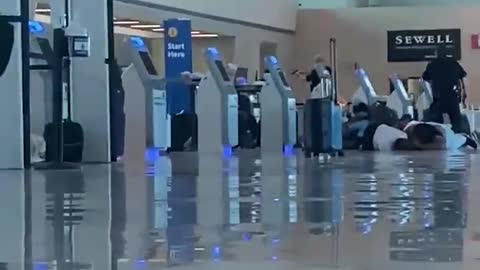 Footage of the suspect shooting a gun in the air inside Dallas Love Field