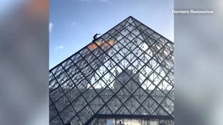 Climate activists scale Louvre's glass pyramid