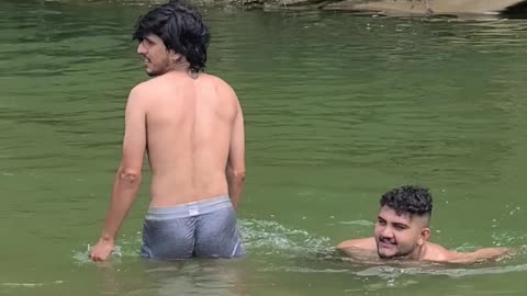 2 boys swimming in tha river