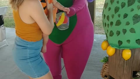 Houston mascot party character Barney picks lemons game at a city ranch birthday celebration