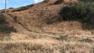 Guy bike goes for small dirt hill jump fails falls into dirt