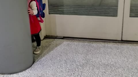 Adorable Toddler Girl playing peek-a-boo at airport will make your day