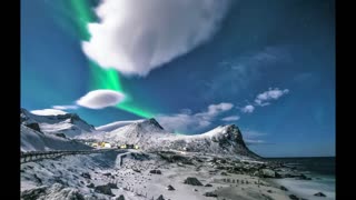 The glow of the north Northern Lights in Norway - man & camera