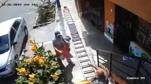 Man Shakes Ladder Vigorously Because The Worker Is Blocking His Path; Guy Falls To Sidewalk In Pain