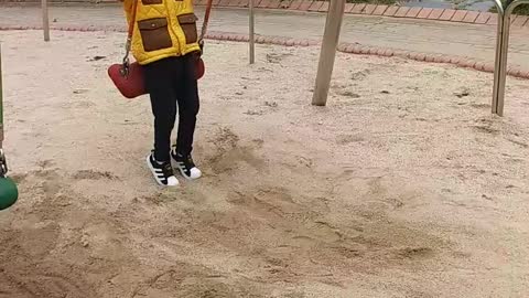 Child playing alone on the playground