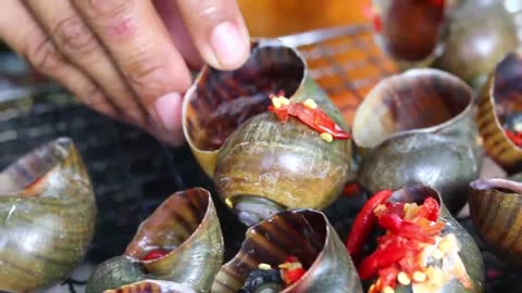 Yummy Mouth Watering Eating Snail Very Spicy _ Grilled Snail Eating with Spicy Sauce