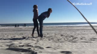 Girl getting flipped over by friend faceplants