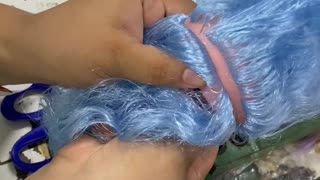 Doll Gets Blue Hair Sewn On