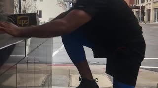 Man blue pants jumping on black ledge