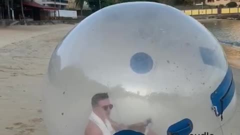 Man Enjoys a Trip to the Beach in Isolation Bubble