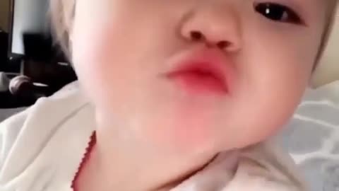 toddler saying hi and giving kisses on camera